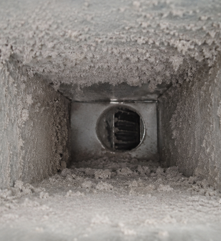 Professional air vent cleaning service inspecting HVAC vents in a Lewisville home.